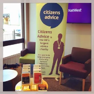 Large Citizens Advice poster reading 'UK’s largest advice charity' alongside displayed leaflets